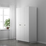 Minimalist white cabinet with sleek, protective handles near window.