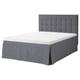 The MOSTERHAMN bed in grey a fabric headboard and matching skirt, presenting a modern and comfortable design perfect for contemporary bedroom decor.