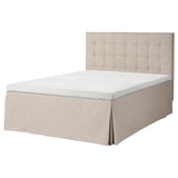 Light gray MOSTERHAMN bed with tufted headboard and white mattress.