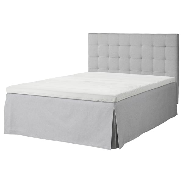 Gray tufted headboard bed with white mattress, removable cover, boxy design.