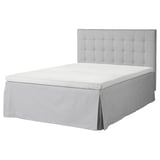 Gray tufted headboard bed with white mattress, removable cover, boxy design.