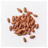 Scattered almonds on a plain white background. A healthy snack option for energy.
