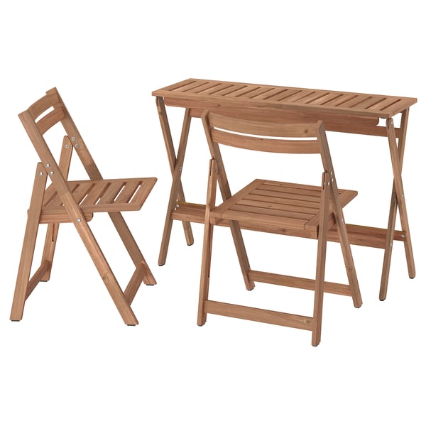NÄMMARÖ set: light brown acacia wood outdoor table and two foldable chairs.