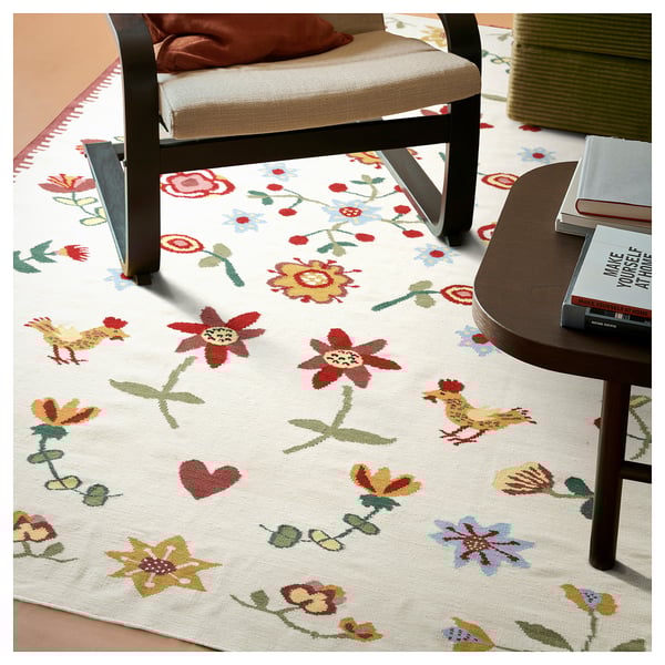 Colorful floral rug under black chair