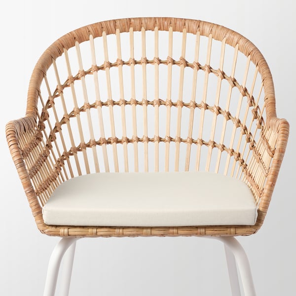 A well-crafted wicker chair with armrests, featuring intricate woven patterns and a cushioned seat, offering comfort and elegance.