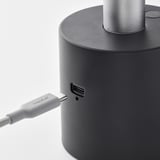 Black portable lamp with usb-c charging port, connected to a usb-c cable.