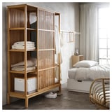 NORDKISA bamboo wardrobe with open shelves and sliding door, natural color, in minimalist bedroom setting.