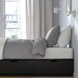 Modern storage bed with 3 drawers, space-saving design, smooth close feature.