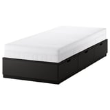 A NORDLI black bed frame with 3 drawers and a white mattress, perfect for small spaces.