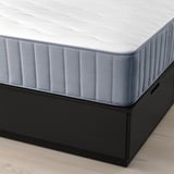 Image showing a NORDLI bed frame with drawers and a mattress. The bed has three large, soft-closing drawers underneath for storage.