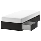 NORDLI black bed frame with 3 drawers and white mattress.