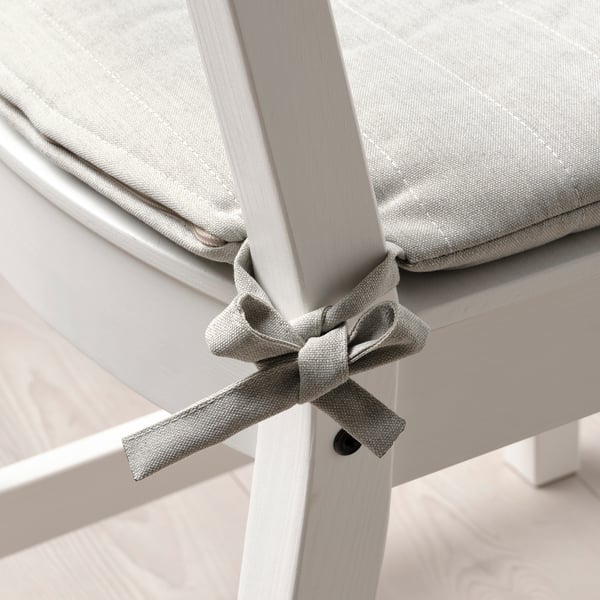 Chair cushion with bow tie, reversible.