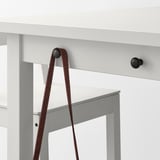 A white NORDVIKEN bar table with hooks and drawer, featuring a brown leather strap.