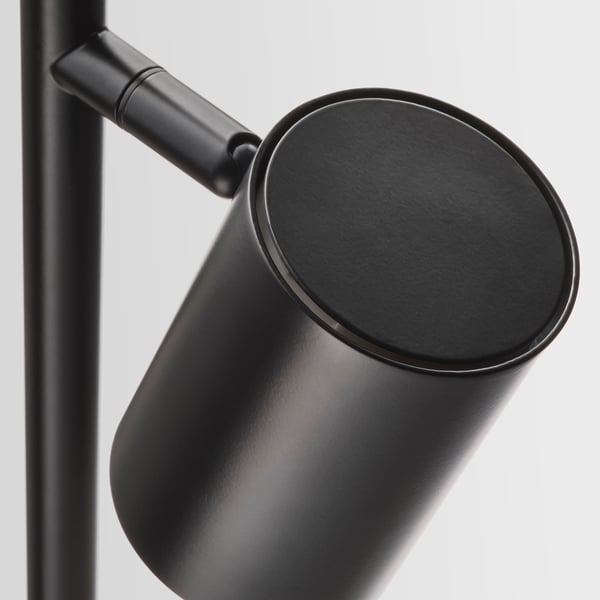 Modern black lamp with cylindrical shade and extendable arm, showcasing sleek design and high-quality finish.