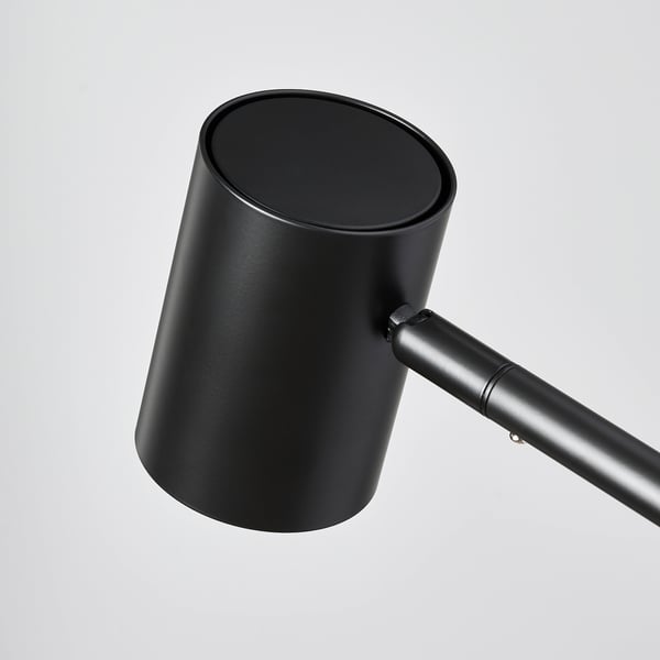 Modern black lamp with adjustable arm and sleek design. High-quality materials and finish.