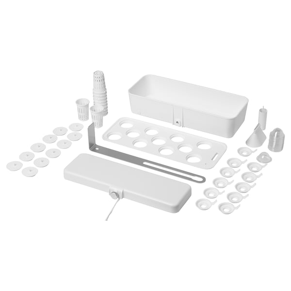 A white indoor plant growing kit, including a lamp, trays, and various accessories.