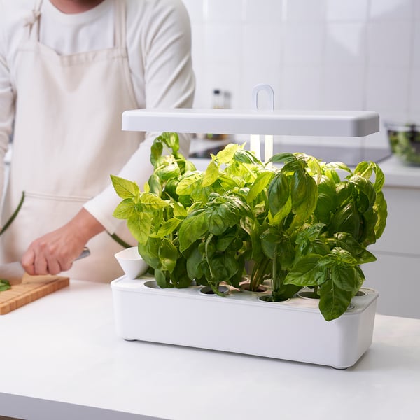 Nysaettra indoor herb kit with light. White, compact design fits on counter. Adjustable light for indoor plant growth.