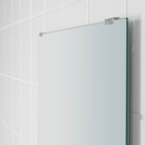 Modern, frameless mirror with sleek, fixed glass shelf. Clean, minimalist design. Slim, chrome fixtures hold it securely.