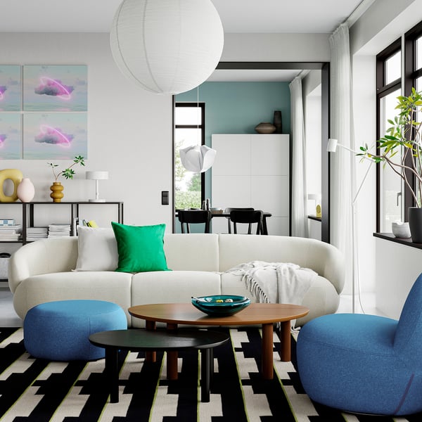 Modern scandinavian coffee table, örträsk, on patterned rug with white sofa and blue armchairs.