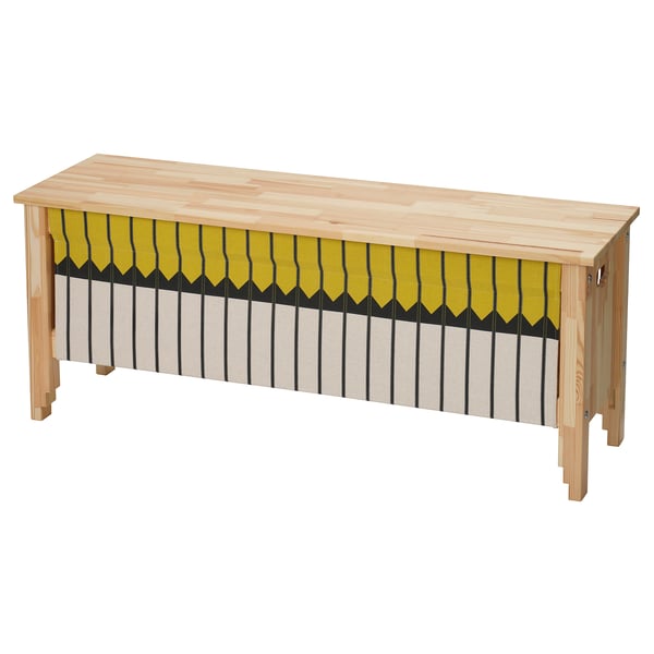 OMMJÄNGE bench with a yellow and black striped cover. Made of pine with a woven fabric, it has a rectangular shape and traditional charm.