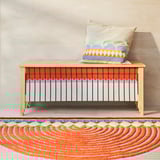 OMMJÄNGE bench, multicolored, rectangular, woven fabric, light wood legs, half-moon rug below.