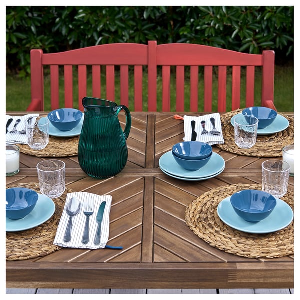 Red bench with blue table setting.