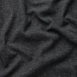 Black fabric close-up showcasing textured, woven, recycled gunnared polyester with mélange effect.