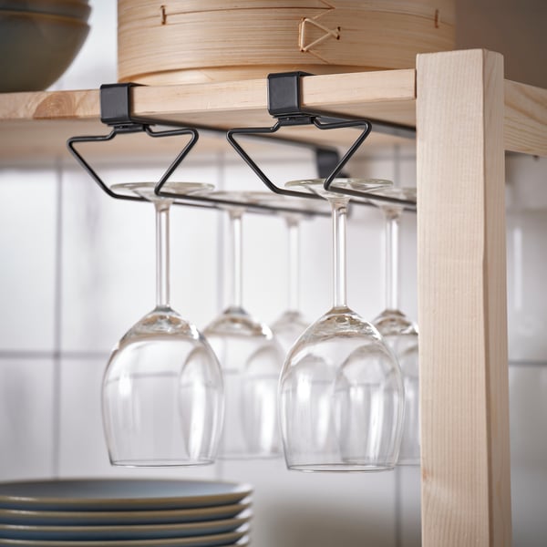 Wooden shelf with hanging wine glass holder, three empty wine glasses suspended.