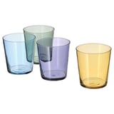 Four PAPPERSBJÖRK glasses in blue, green, purple, and yellow, made of glass and colored paint, arranged in a group.