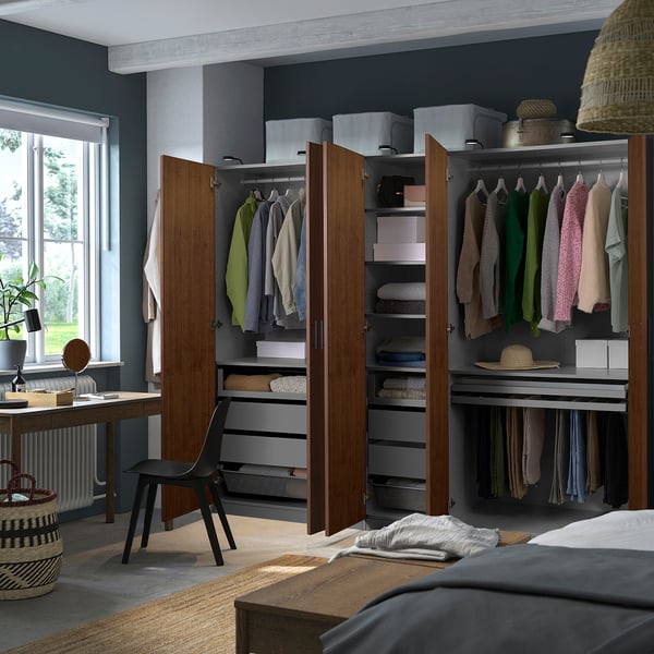 Bedroom with large wardrobe, hinge doors reveal clothes, shelves, lights.