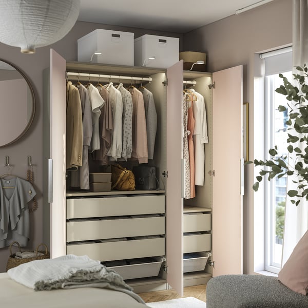 Wardrobe with clothes, accessories, drawers, shelves, adjustable feet, and lighting in bedroom.