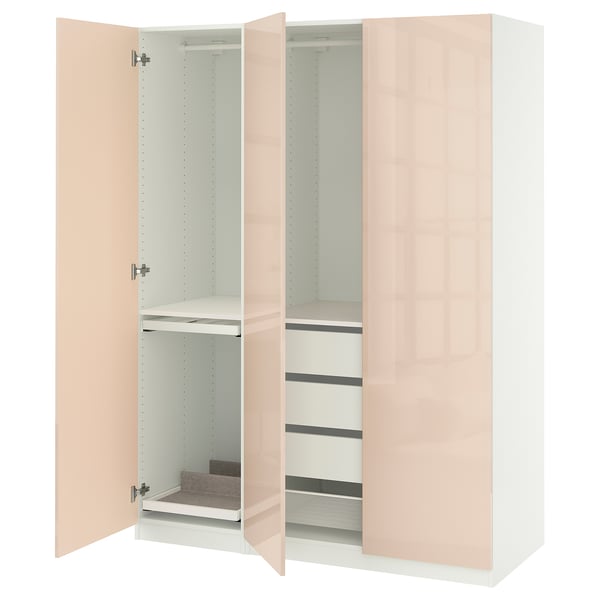 A white PAX wardrobe with peach-colored doors, showcasing organized internal storage.
