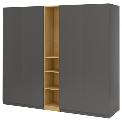 A grey PAX wardrobe with three doors, one open to show internal shelves.