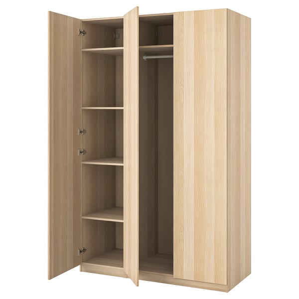 An open light wood-colored ikea PAX wardrobe. It has multiple shelves and a hanging rod inside.