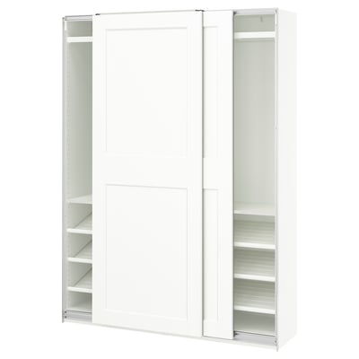 A white PAX wardrobe with sliding doors and adjustable shelves.
