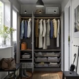 Organized closet with hanging jackets, folded sweaters, and mesh baskets; adjustable feet, lighting, front-access basket.