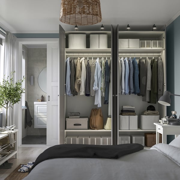 Modern closet with open doors, showing shirts, jackets, and folded clothes. Shelves, bins, soft-close hinges.