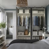 Modern closet with open doors, showing shirts, jackets, and folded clothes. Shelves, bins, soft-close hinges.