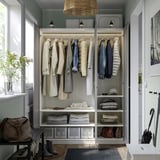Modern open closet with clothes, shelves, and lighting; ideal for organized storage.