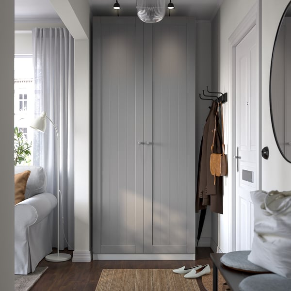 Modern living room with grey PAX wardrobe, couch, and decor.