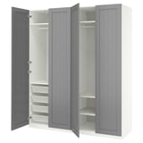 A grey ikea PAX wardrobe with open doors, revealing shelves and baskets.