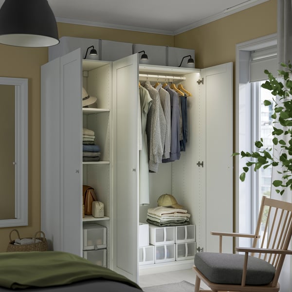 White wardrobe with clothes, towels, adjustable feet & lighting