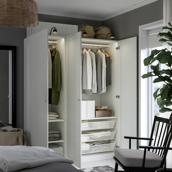 Well-organized wardrobe with clothes, shelves, and drawers. Integration of lighting, air-circulating mesh baskets, and adjustable compartments.