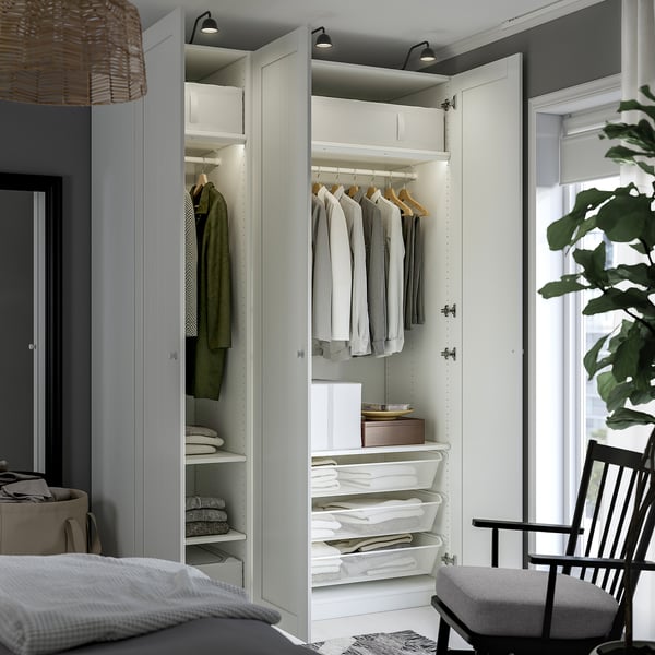 Modern closet with clothes and storage, integrated lighting, minimalist decor.