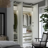 Modern closet with clothes and storage, integrated lighting, minimalist decor.