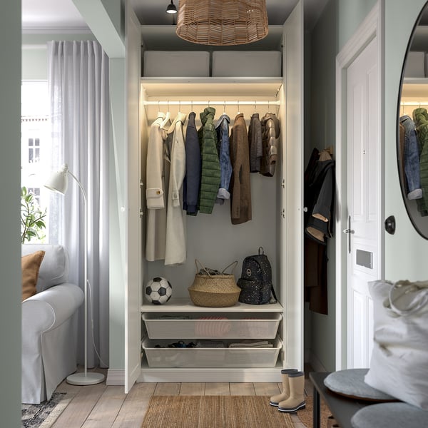 Modern wardrobe organizes clothes with hanging rail, shelves, and basket for storage. Soft-closing hinges visible, adjustable feet for floor leveling.