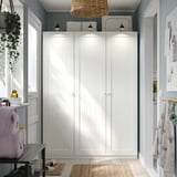 White PAX wardrobe centered with pendant lamp, minimalist design
