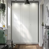 Large white PAX wardrobe with lights, between window and door.