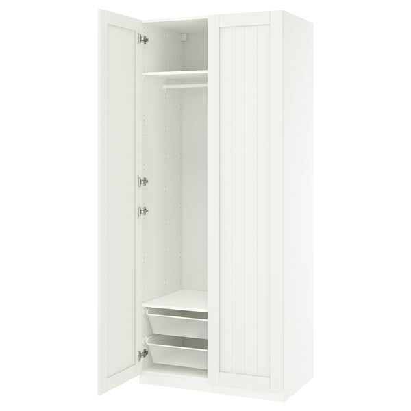 An open white ikea PAX wardrobe with shelves and mesh baskets.
