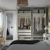 Modern bedroom with walk-in closet, organized storage, integrated lighting.